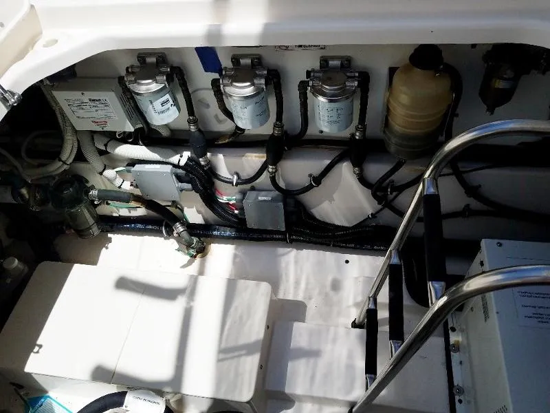 Slide: The Image of Engine compartment of a 2017 Pursuit S 408 Sport boat with various components. - 29
