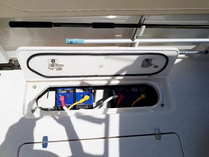 Slide: The Image of Battery compartment of a 2017 Pursuit S 408 Sport boat with open hatch. - 34