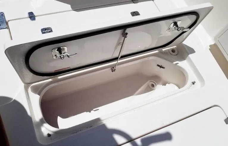 Slide: The Image of Open storage compartment on a 2017 Pursuit S 408 Sport boat. - 37