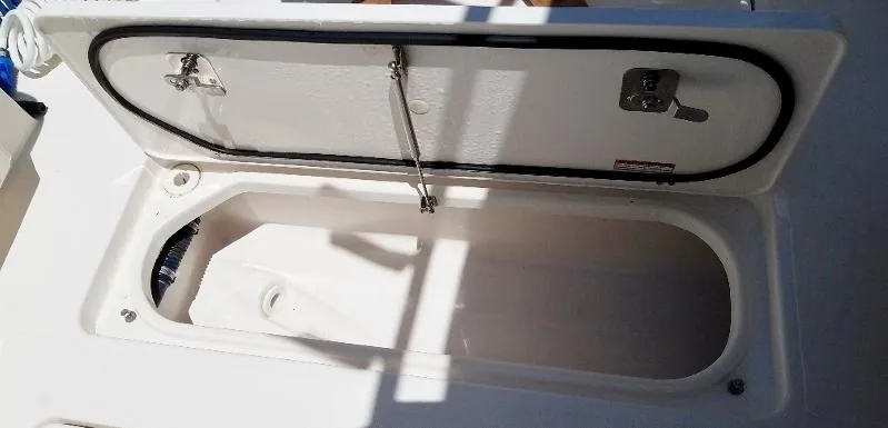 Slide: The Image of Open storage compartment on a 2017 Pursuit S 408 Sport boat. - 38