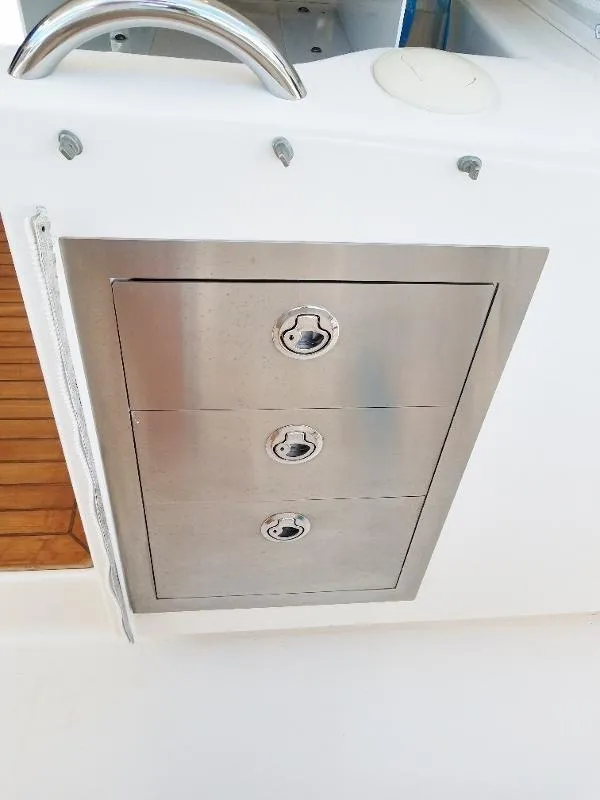 Slide: The Image of Stainless steel storage drawers on a 2017 Pursuit S 408 Sport boat. - 41