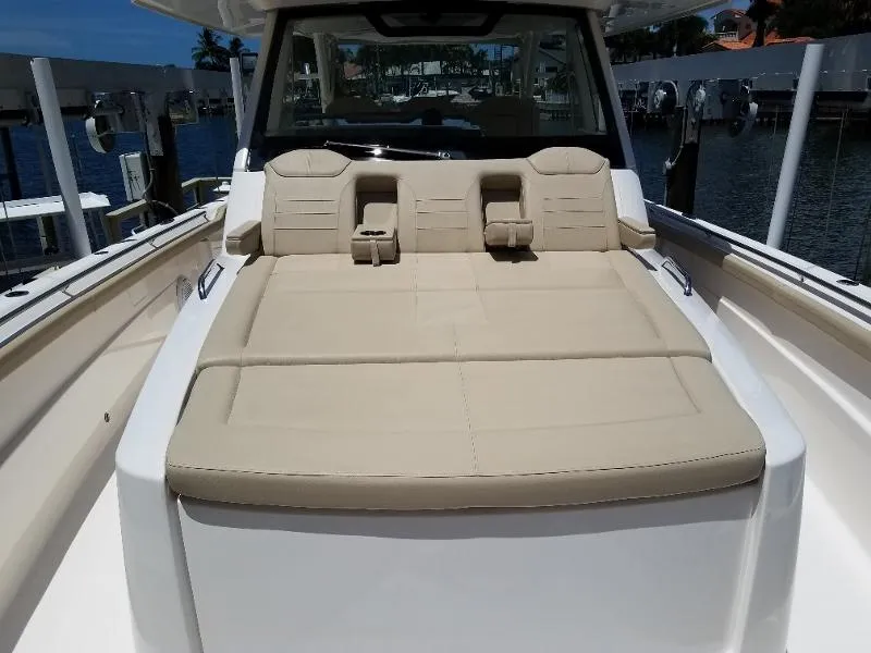 Slide: The Image of 2017 Pursuit S 408 Sport boat with beige cushioned seating area. - 43