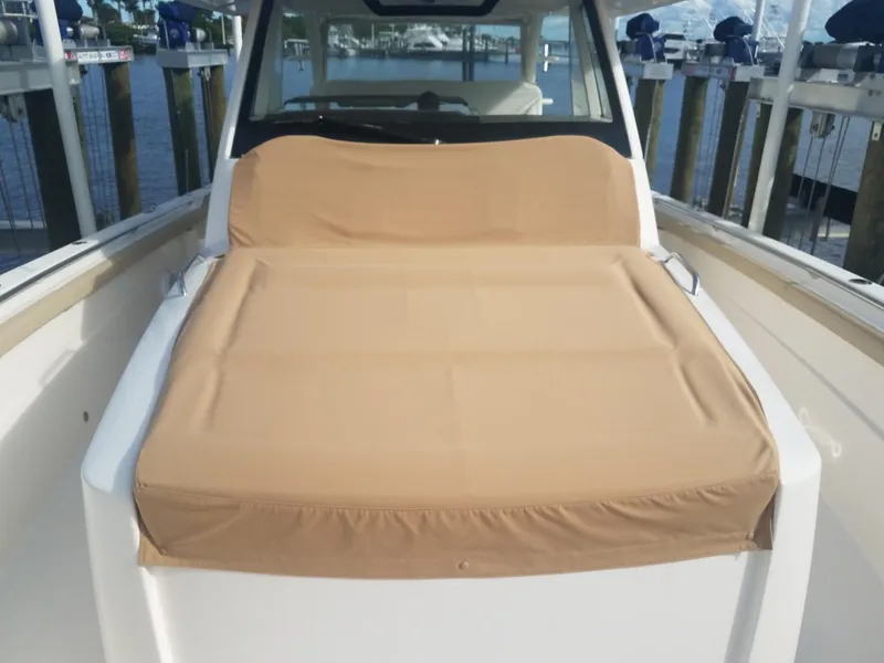 Slide: The Image of 2017 Pursuit S 408 Sport boat with tan cushioned seating on deck. - 44