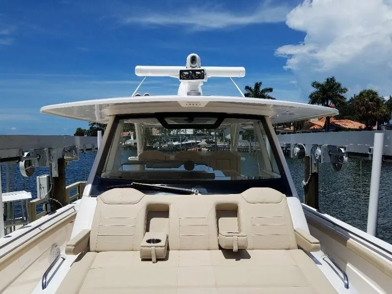 Slide: The Image of 2017 Pursuit S 408 Sport boat docked with beige seating and blue sky background. - 47