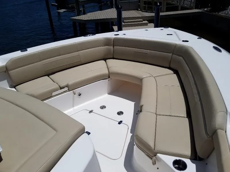 Slide: The Image of 2017 Pursuit S 408 Sport boat with spacious beige seating area. - 48