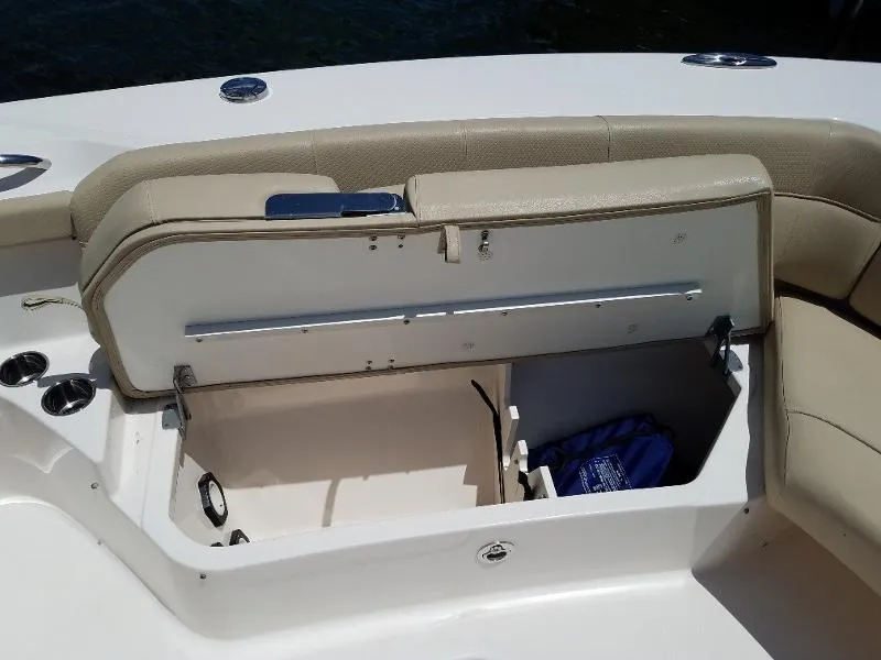 Slide: The Image of 2017 Pursuit S 408 Sport boat with open storage compartment and beige seating. - 51