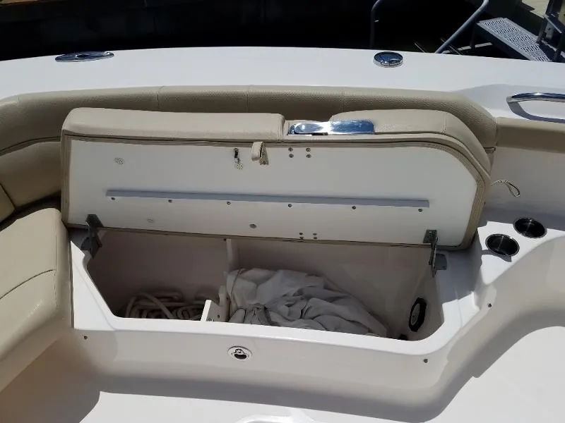 Slide: The Image of Open storage compartment on a 2017 Pursuit S 408 Sport boat. - 52