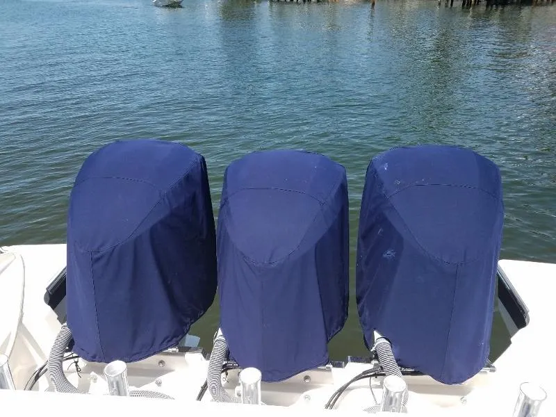 Slide: The Image of 2017 Pursuit S 408 Sport boat with three covered outboard motors. - 62