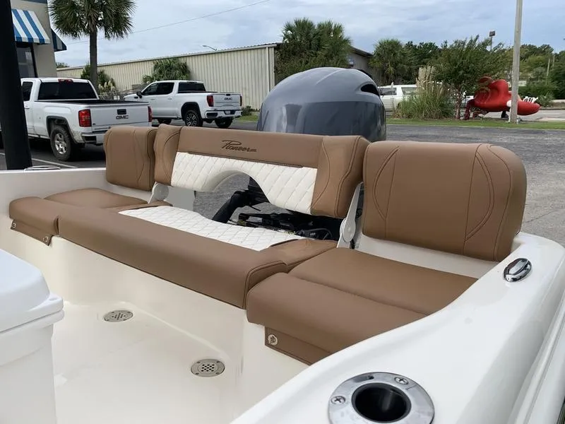 Slide: The Image of 2025 Pioneer Islander 180 boat interior with tan and white seating. - 10