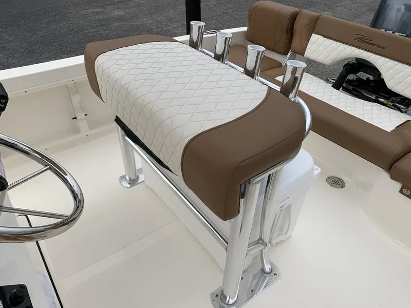 Slide: The Image of Pioneer Islander 180 boat interior, 2025 model, featuring cushioned seating and rod holders. - 13