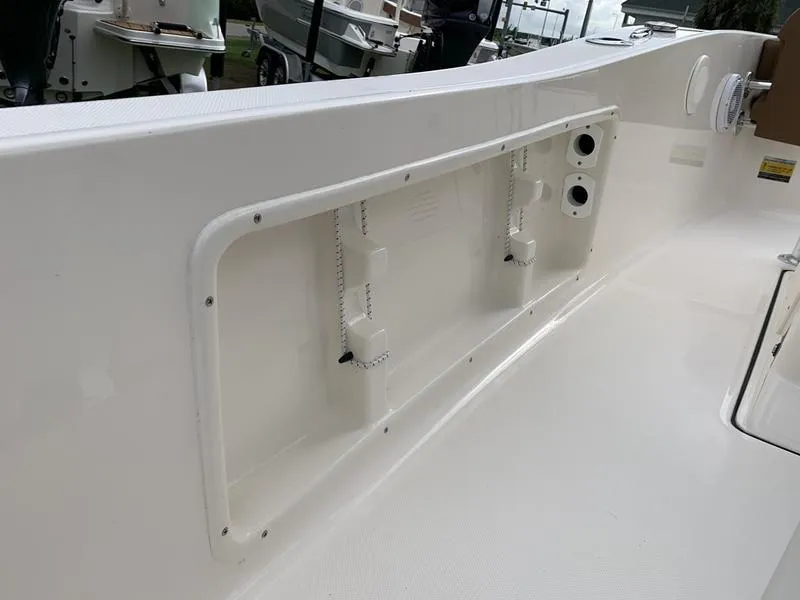 Slide: The Image of 2025 Pioneer Islander 180 boat interior detail with storage compartment. - 15