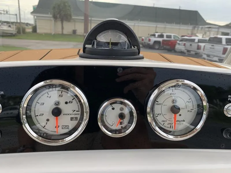 Slide: The Image of Dashboard of 2025 Pioneer Islander 180 boat with gauges and compass. - 17