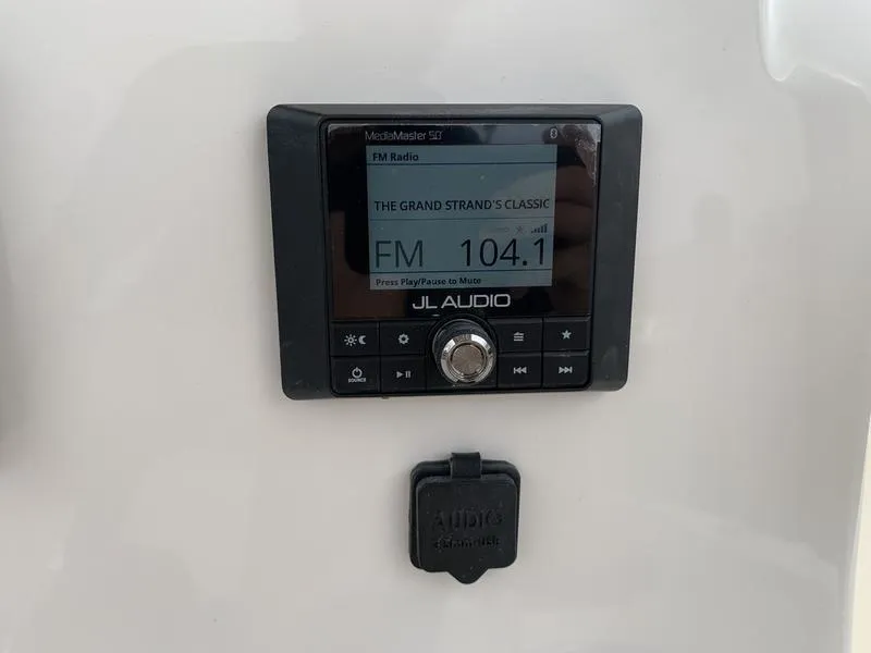 Slide: The Image of JL Audio radio display on 2025 Pioneer Islander 180 boat. - 18