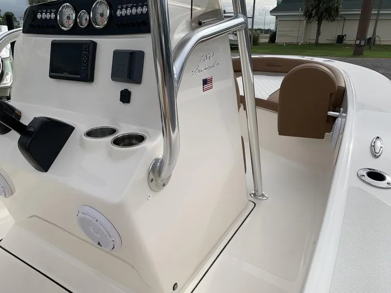 Slide: The Image of 2025 Pioneer Islander 180 boat console with controls and cup holders. - 20