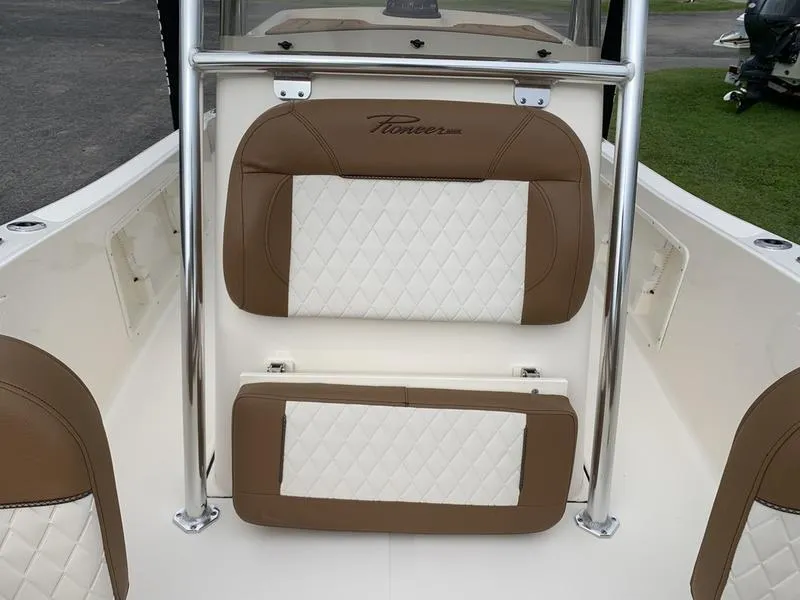 Slide: The Image of 2025 Pioneer Islander 180 boat interior with brown and white cushioned seating. - 23