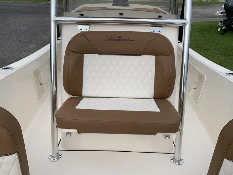 Slide: The Image of 2025 Pioneer Islander 180 boat seat with brown and white diamond-pattern upholstery. - 24
