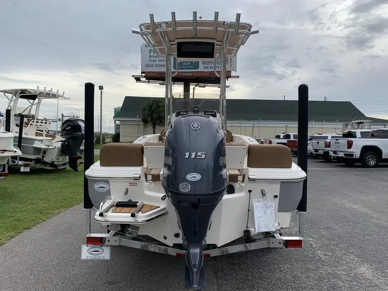 Slide: The Image of 2025 Pioneer Islander 180 boat with Yamaha 115 outboard motor, parked outdoors. - 3
