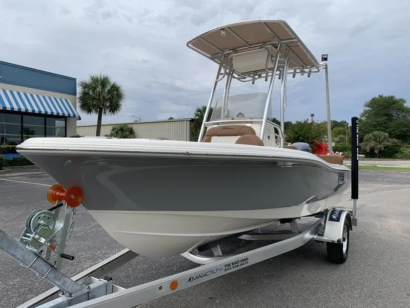 Slide: The Image of 2025 Pioneer Islander 180 boat on trailer, parked outdoors. - 8