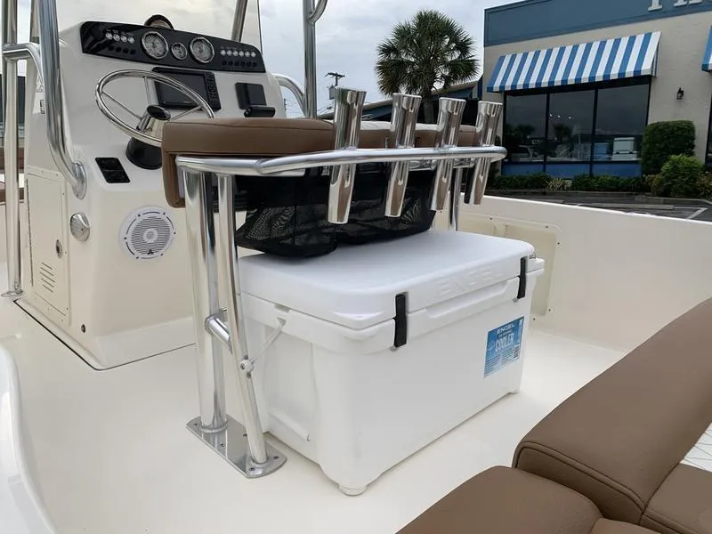 Slide: The Image of 2025 Pioneer Islander 180 boat interior with console, seating, and rod holders. - 9