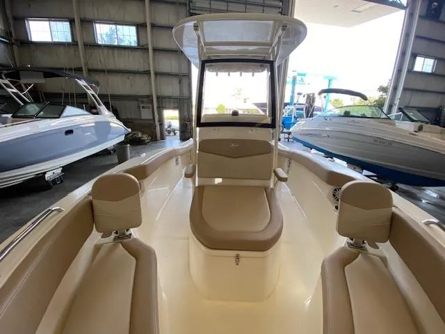 Slide: The Image of 2025 Scout 215 XSF boat interior in a showroom. - 11