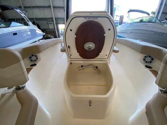 Slide: The Image of 2025 Scout 215 XSF boat interior with open fish box cooler. - 12