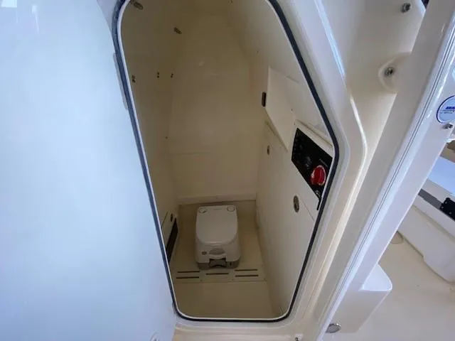Slide: The Image of 2025 Scout 215 XSF boat interior with compact toilet. - 13