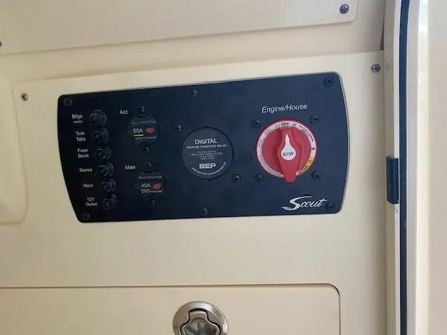 Slide: The Image of Control panel of a 2025 Scout 215 XSF boat with digital display and switches. - 14