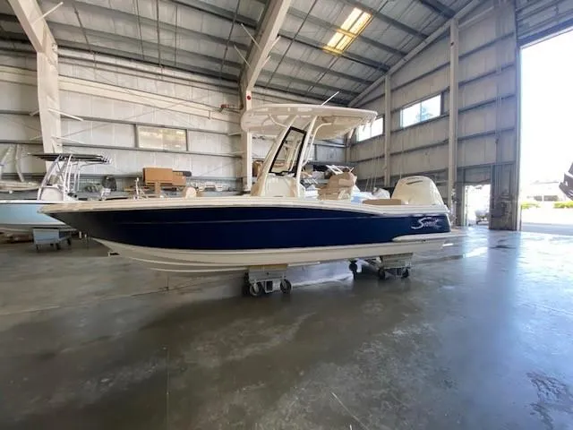 Slide: The Image of 2025 Scout 215 XSF boat in a warehouse. - 3