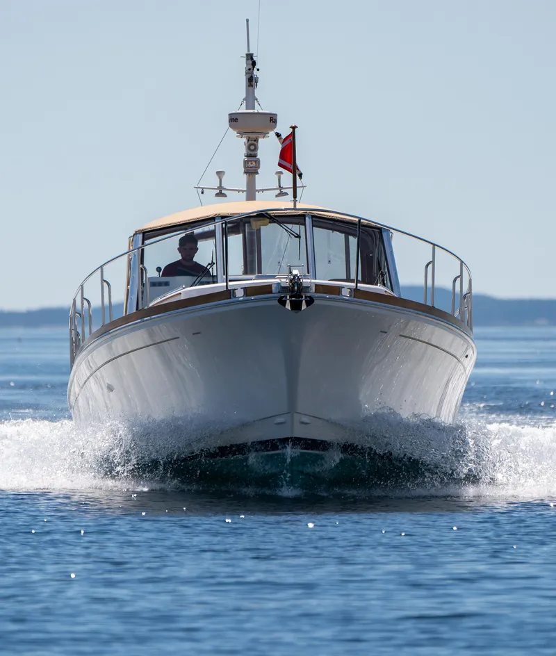 Slide: The Image of Grand Banks Eastbay 43 Ex 2000 cruising on a calm blue sea with American flag. - 12