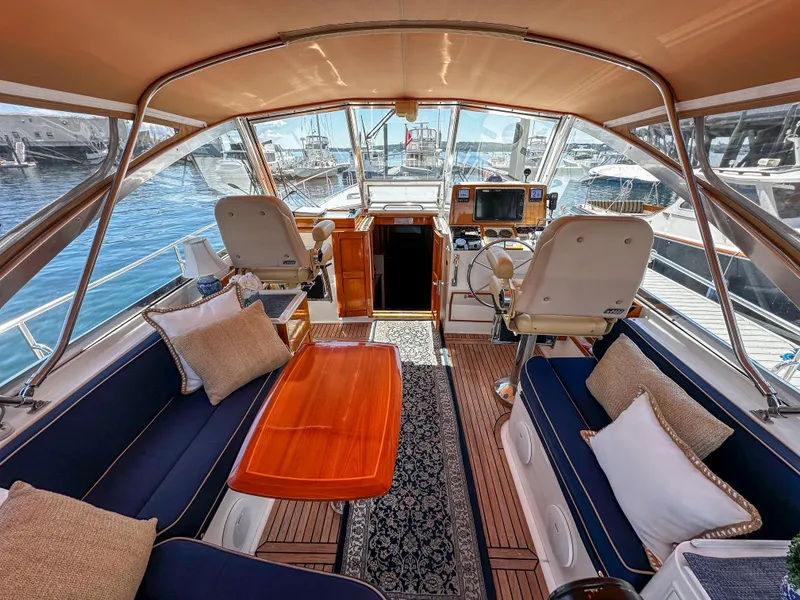 Slide: The Image of Luxurious interior of 2000 Grand Banks Eastbay 43 Ex yacht with elegant seating and helm station. - 31