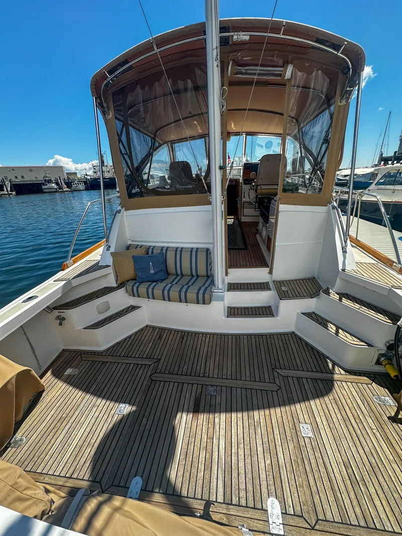 Slide: The Image of 2000 Grand Banks Eastbay 43 Ex yacht with spacious deck and seating area. - 23