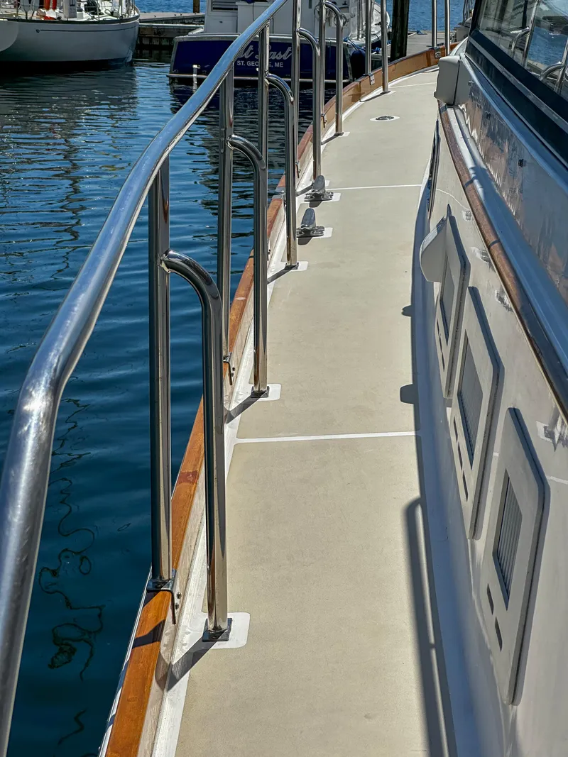 Slide: The Image of 2000 Grand Banks Eastbay 43 Ex yacht deck with stainless steel railings at marina. - 25