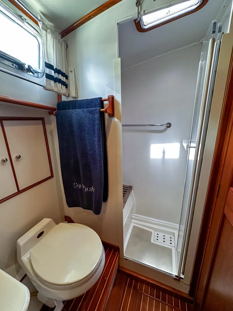 Slide: The Image of Bathroom of 2000 Grand Banks Eastbay 43 Ex with shower, toilet, and storage cabinets. - 36