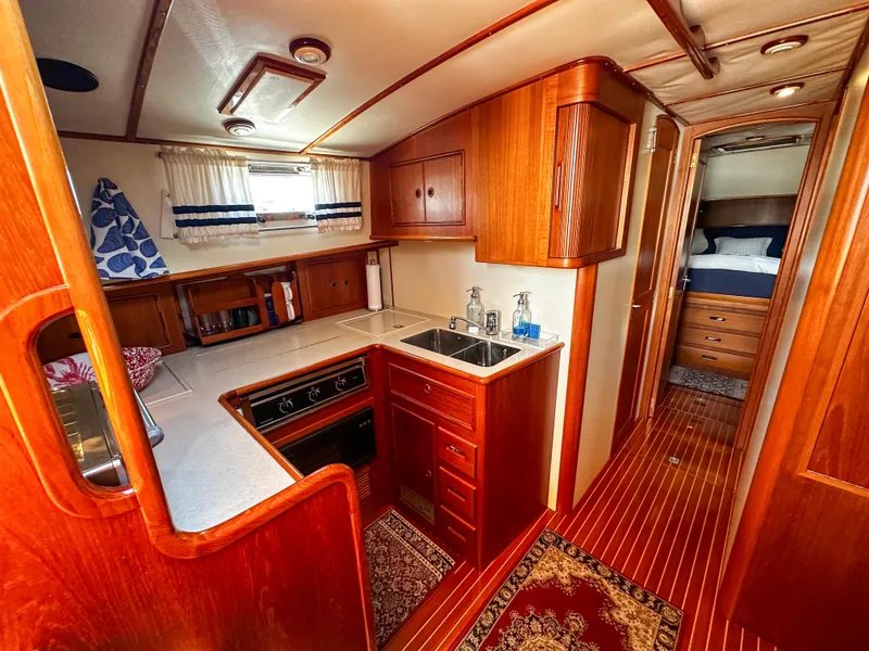 Slide: The Image of Luxurious 2000 Grand Banks Eastbay 43 Ex yacht interior with wooden cabinetry and modern kitchen. - 37