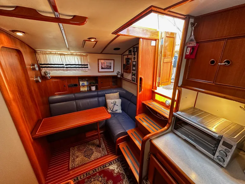 Slide: The Image of Luxurious interior of 2000 Grand Banks Eastbay 43 Ex yacht with cozy seating and wooden finishes. - 47