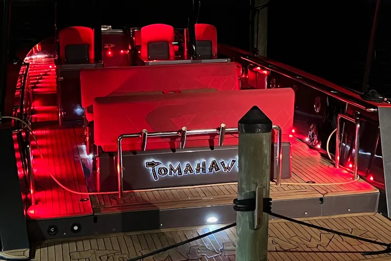 Slide: The Image of Red-lit 2008 Fjord Express boat interior with "Tomahawk" sign at night. - 10