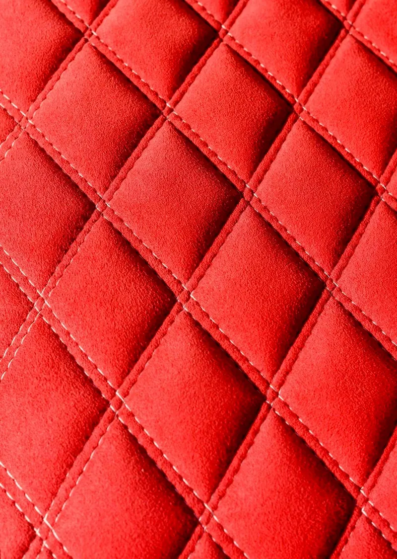 Slide: The Image of Red quilted fabric texture, close-up, showcasing diamond pattern stitching. - 21