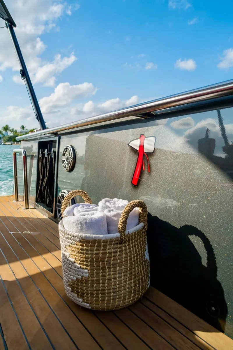 Slide: The Image of Basket with towels on 2008 Fjord Express boat deck under blue sky. - 25