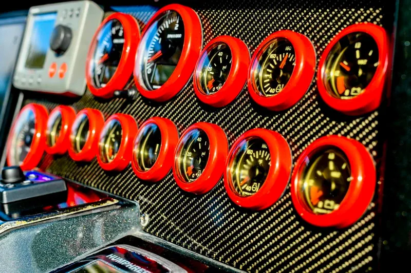 Slide: The Image of Dashboard of a 2008 Fjord Express with red-rimmed gauges and carbon fiber panel. - 28