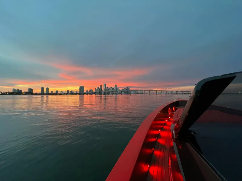 Slide: The Image of Fjord Express 2008 boat at sunset with city skyline and bridge in background. - 8