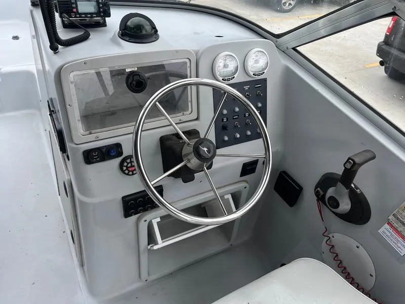 Slide: The Image of 2004 Pro-Line 2200 Duel Console boat cockpit with steering wheel and control panel. - 10