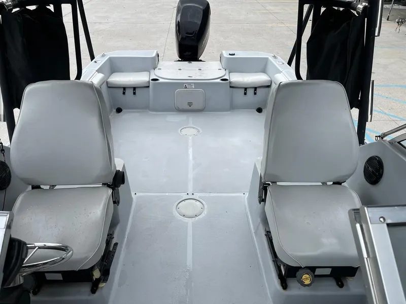 Slide: The Image of 2004 Pro-Line 2200 Dual Console boat interior with seating and motor. - 11