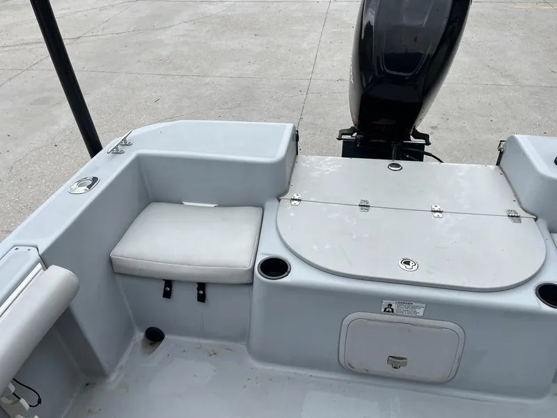 Slide: The Image of 2004 Pro-Line 2200 Dual Console boat interior with seating and storage compartments. - 13