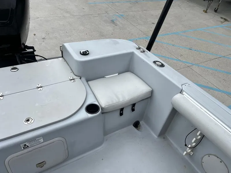 Slide: The Image of 2004 Pro-Line 2200 Dual Console boat interior with seating and storage compartments. - 14