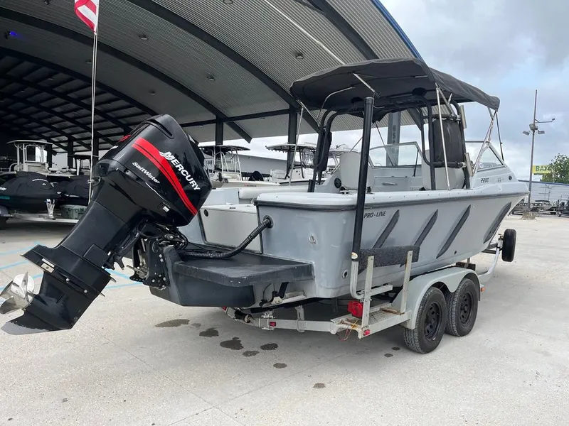 Slide: The Image of 2004 Pro-Line 2200 Dual Console boat with Mercury outboard motor on trailer. - 2