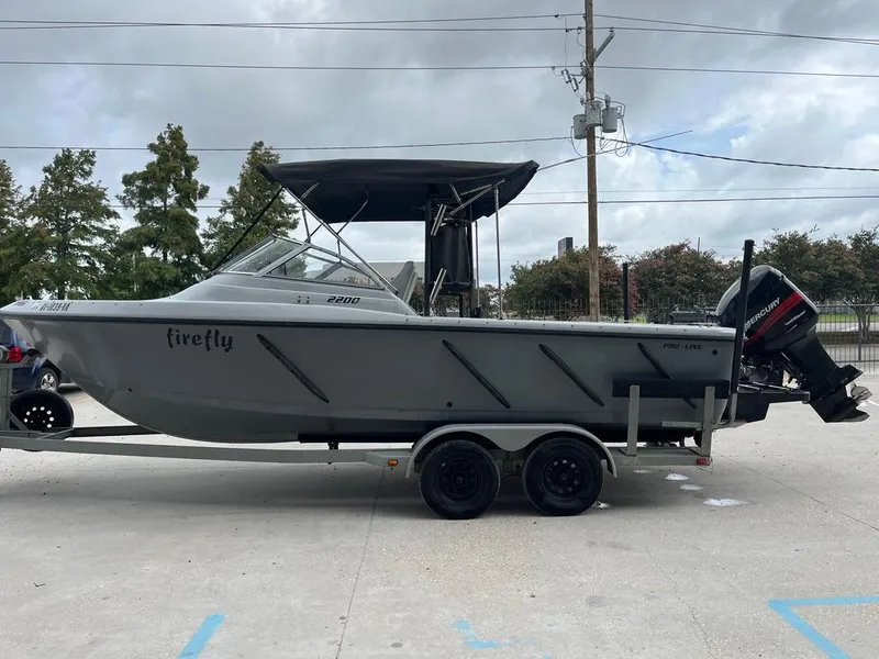 Slide: The Image of 2004 Pro-Line 2200 Duel Console boat on trailer with outboard motor. - 5