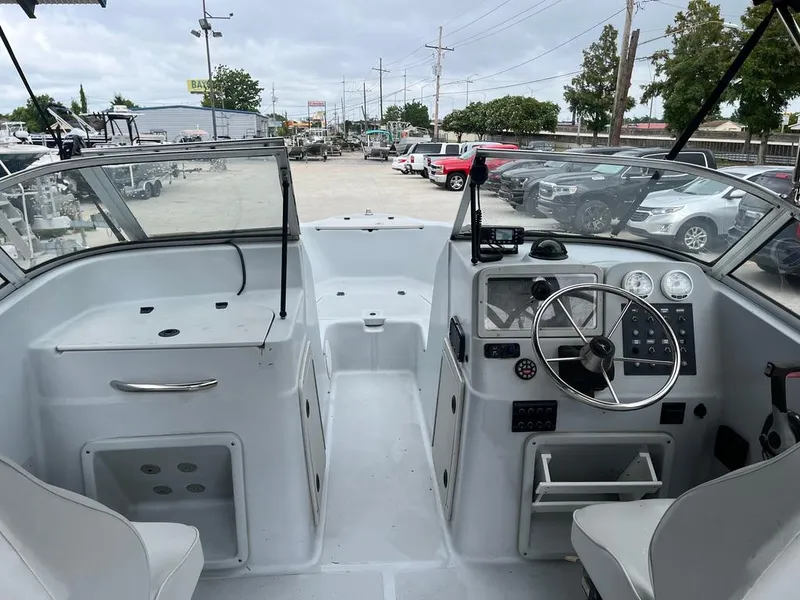 Slide: The Image of 2004 Pro-Line 2200 Dual Console boat interior with steering wheel and dashboard. - 9