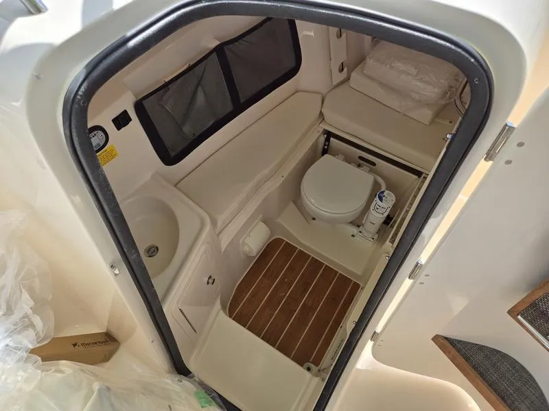 Slide: The Image of 2024 Grady-White Freedom 307 boat interior bathroom with toilet and sink. - 11