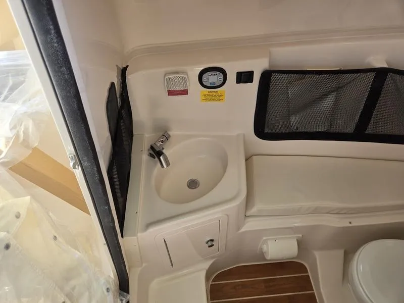 Slide: The Image of 2024 Grady-White Freedom 307 boat interior with sink and seating area. - 12