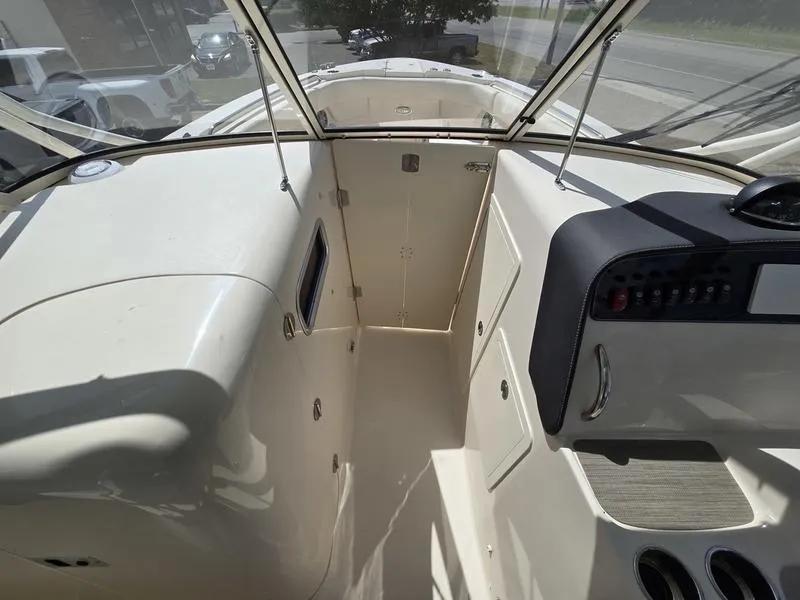 Slide: The Image of 2024 Grady-White Freedom 307 boat interior with helm and cabin entrance. - 13